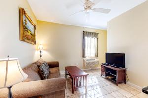 a living room with a couch and a tv at The Colonels Suites #4 in Northeast Harbor