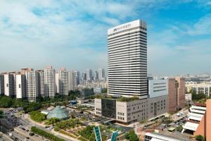 a tall building with a sign on it in a city at JW Marriott Hotel Seoul in Seoul