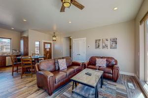 a living room with two leather couches and a table at Rim View 7 in Spanish Valley