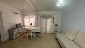 a living room with a table and a couch at alaguthe in Olavarría