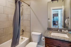 a bathroom with a toilet and a sink and a tub at Rim View 7 in Spanish Valley +27 photos