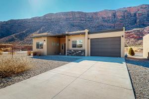 a house with a mountain in the background at Rim View 7 in Spanish Valley