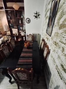 a dining room with a long black table and chairs at ElaPhos HOUSE in Kiriákion +19 photos