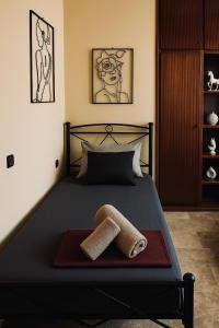 a bedroom with a bed with two towels on it at ElaPhos HOUSE in Kiriákion