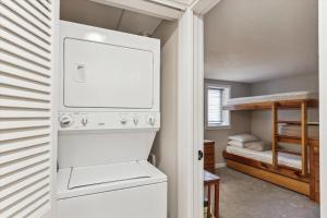 a laundry room with a washer and dryer and a bunk bed at Lodge Condo 26 in Stowe