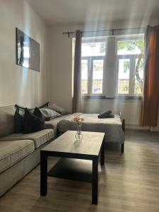 a living room with a couch and a coffee table at New May Apartment in Staré Mesto