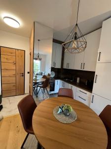a kitchen and dining room with a wooden table at Bjelasnica Family Peak Villa Monti in Babin Do