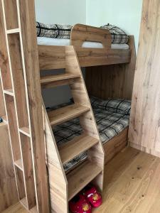 a room with bunk beds and a bed in it at Bjelasnica Family Peak Villa Monti in Babin Do +24 photos