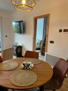 a dining room with a wooden table and chairs at Bjelasnica Family Peak Villa Monti in Babin Do