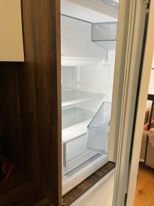 an empty refrigerator with its door open in a kitchen at Bjelasnica Family Peak Villa Monti in Babin Do