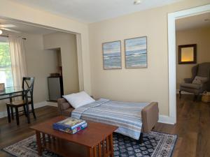a living room with a bed and a table at Casual Living Extended Stay Hotels in Algonquin +18 photos