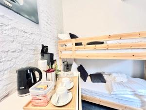a bedroom with a bunk bed and a desk with a coffee maker at Casa Terraza in Hasselt