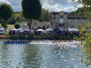 a group of people in boats on a river at Les appartements de l'Orangerie in Jarnac