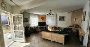 a living room with a couch and a table at Magyar Tenger Pihenőház, house for 8 with garden at Balaton in Balatonkenese