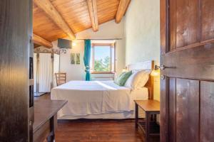 a bedroom with a bed and a window at Country House Binnella in Cingoli +48 photos