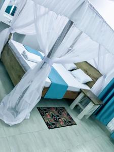 a bedroom with a tent with a bed and a rug at Changamwe accomodations in Mombasa +5 photos