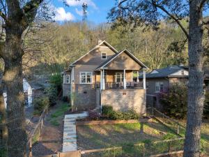 a house in the middle of a yard with trees at Iris Manor Luxury Modern Stay Near UAB in Birmingham