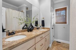 a bathroom with two sinks and a shower at Iris Manor Luxury Modern Stay Near UAB in Birmingham +21 photos