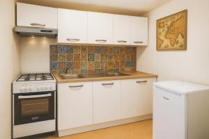 a kitchen with white cabinets and a stove at Segesta - Le Bouquet in Salemi