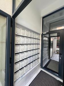 a door to a building with a lot of lockers at Luxury & Green Apartments Modern Stay with Private Terrace in Pristina