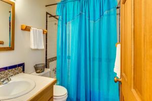 baño con cortina de ducha azul y lavamanos en 8 Mi to Taos Ski Valley! Peaceful Mtn-View Condo, en Valdez 19 fotos más