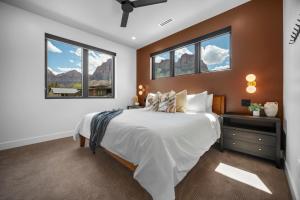 a bedroom with a bed and two windows at Montclair at Zion in Springdale +122 photos