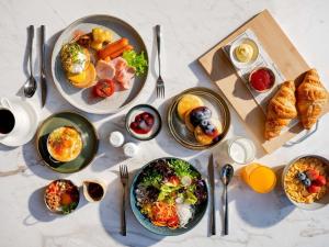 a table with many plates of food on it at Novotel Rayong Star Convention Centre in Rayong