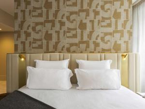 a bedroom with a bed with two white pillows at Le Saint Gervais Hotel & Spa Handwritten Collection in Saint-Gervais-les-Bains