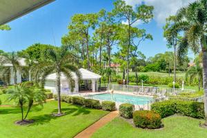 an aerial view of a house with a swimming pool and palm trees at Snowbirds Welcome! Naples Resort Condo Near Golf in Naples
