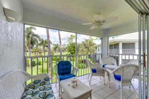 a screened porch with chairs and tables and a ceiling fan at Snowbirds Welcome! Naples Resort Condo Near Golf in Naples