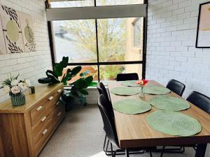 a dining room table with green plates on it at Young unit1 Water Views in Nagambie +6 photos