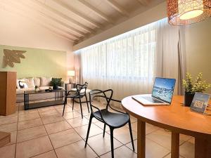a living room with a table with a laptop on it at Coronado Luxury Club and Suites,Oasis in El Quije