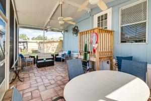 a patio with a white table and chairs at 5 Mi to Manatees! Waterfront Crystal River Home in Crystal River