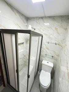 a bathroom with a toilet and a walk in shower at Don Charlie in Veracruz +9 photos