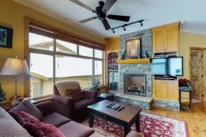 a living room with a couch and a fireplace at Aspens 4607 in Big White