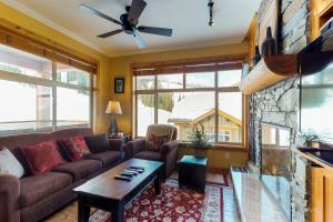 a living room with a couch and a fireplace at Aspens 4607 in Big White