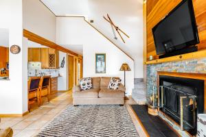 a living room with a couch and a fireplace at Timber Ridge 203 in Silverthorne