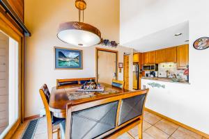 a kitchen with a dining table and a sink at Timber Ridge 203 in Silverthorne +25 photos