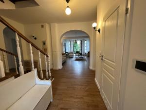 a hallway of a home with a staircase and a door at Dako Mansion, Stylish, Modern, Cosy in Rzeszów