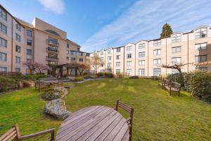 a park with benches in front of a building at Millennium Hotel Queenstown in Queenstown