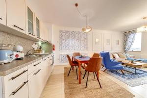 a kitchen and dining room with a table and chairs at Ski Slope Getaway at Grand Monastery by Flat Manаger in Pamporovo