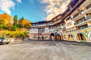 an empty parking lot in front of a large building at Ski Slope Getaway at Grand Monastery by Flat Manаger in Pamporovo