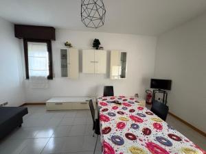 a bedroom with a bed and a table with chairs at Bartoli 8, Viserbella di Rimini in Rimini