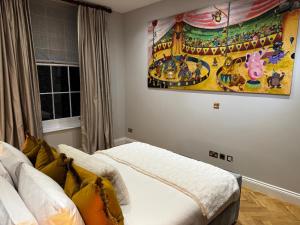 a bedroom with a bed and a painting on the wall at The Victorian Residence in Moffat