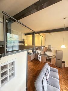 a living room with a couch and a kitchen at Cityscape condos in Dewsbury +5 photos
