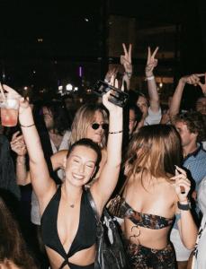 two young women in a crowd at a party at Morada Gaia in Tempate