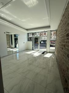 a large empty room with a brick wall and white floors at Vista al mar in Mar del Plata