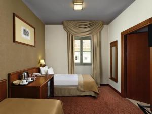 Un pat sau paturi într-o cameră la Mercure Szekesfehervar Magyar Kiraly