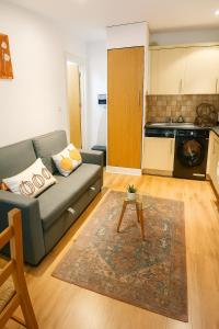 a living room with a couch and a table at Stylish Flat on Cowley a Walk to Oxford Centre in Oxford
