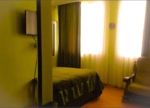 a bedroom with a bed and a mirror and a window at Leli in Sighnaghi